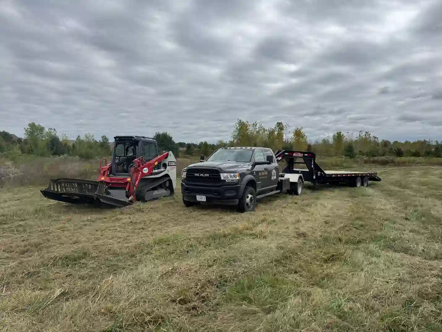 Takeuchi skid steer with brush hog attachment for brush clearing in western Missouri